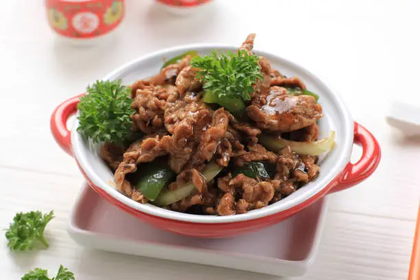 Sapi Lada hitam, Indonesian and Chinese cuisine, stir fried beef with black pepper sauce and red bell peppers, Served on Red Plate