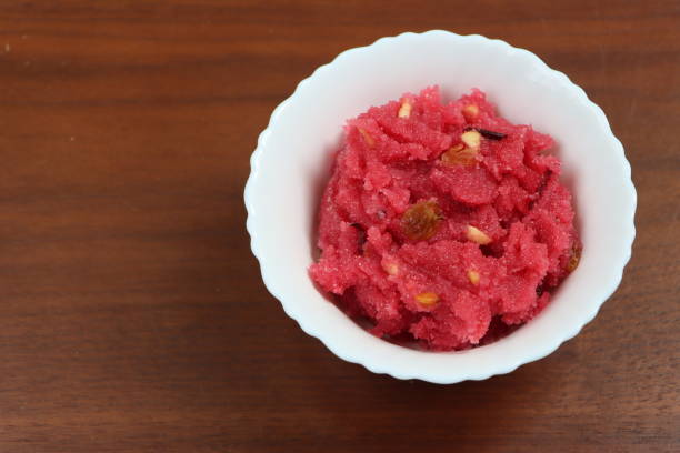 istock Sooji beet root halwa is a Sugar beet-Semolina based sweet dessert pudding from India. Garnished with Cashew/almond nuts and Served in a bowl, festival food 1365063205