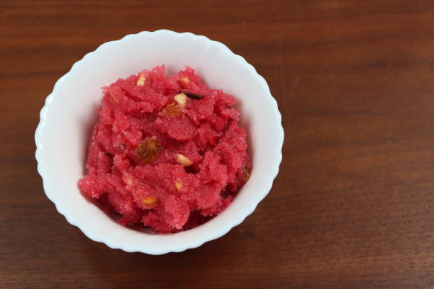 istock Sooji beet root halwa is a Sugar beet-Semolina based sweet dessert pudding from India. Garnished with Cashew/almond nuts and Served in a bowl, festival food 1365063208