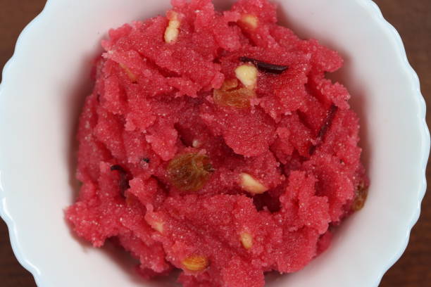 istock Sooji beet root halwa is a Sugar beet-Semolina based sweet dessert pudding from India. Garnished with Cashew/almond nuts and Served in a bowl, festival food 1365063209