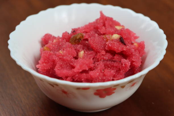 istock Sooji beet root halwa is a Sugar beet-Semolina based sweet dessert pudding from India. Garnished with Cashew/almond nuts and Served in a bowl, festival food 1365063216