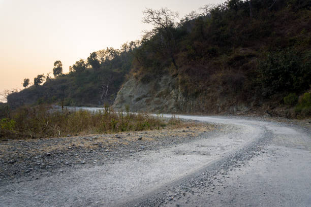 istock An empty asphalt road in rural India surrounded by mountains in lower himalayas. 1365064224
