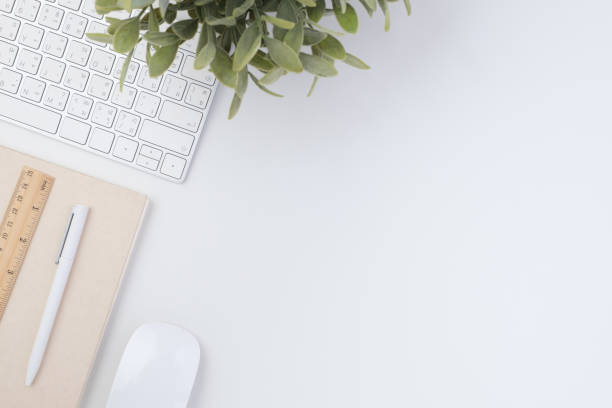 istock top view working desk with keyboard mouse and notebook on white table backgorund 1365067153