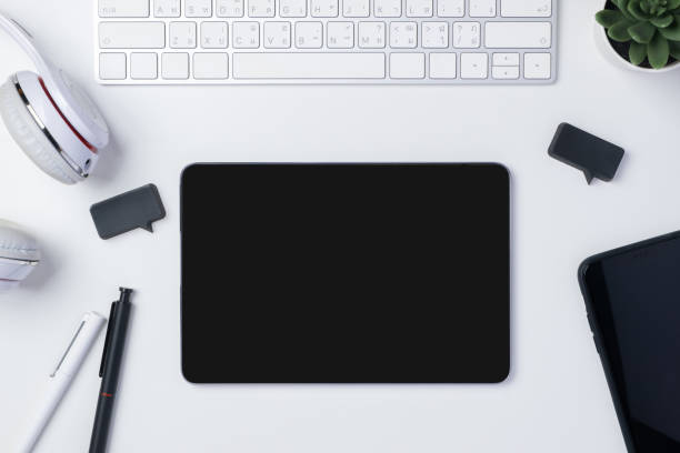 istock top view working desk with keyboard headphone and tablet on white table background 1365067190