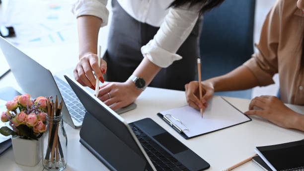 istock Businesswoman explaining new online project on computer tablet to her colleague. 1365067809