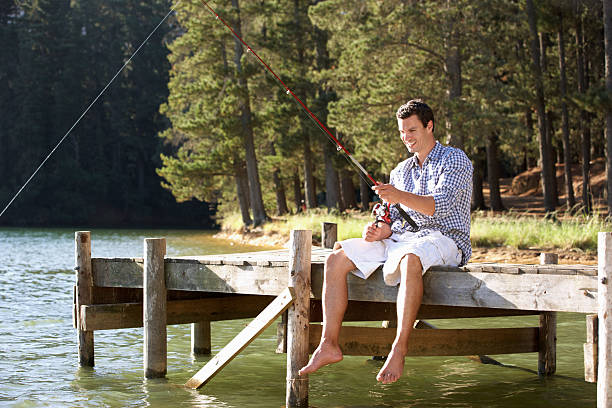 istock Young man fishing 136506855