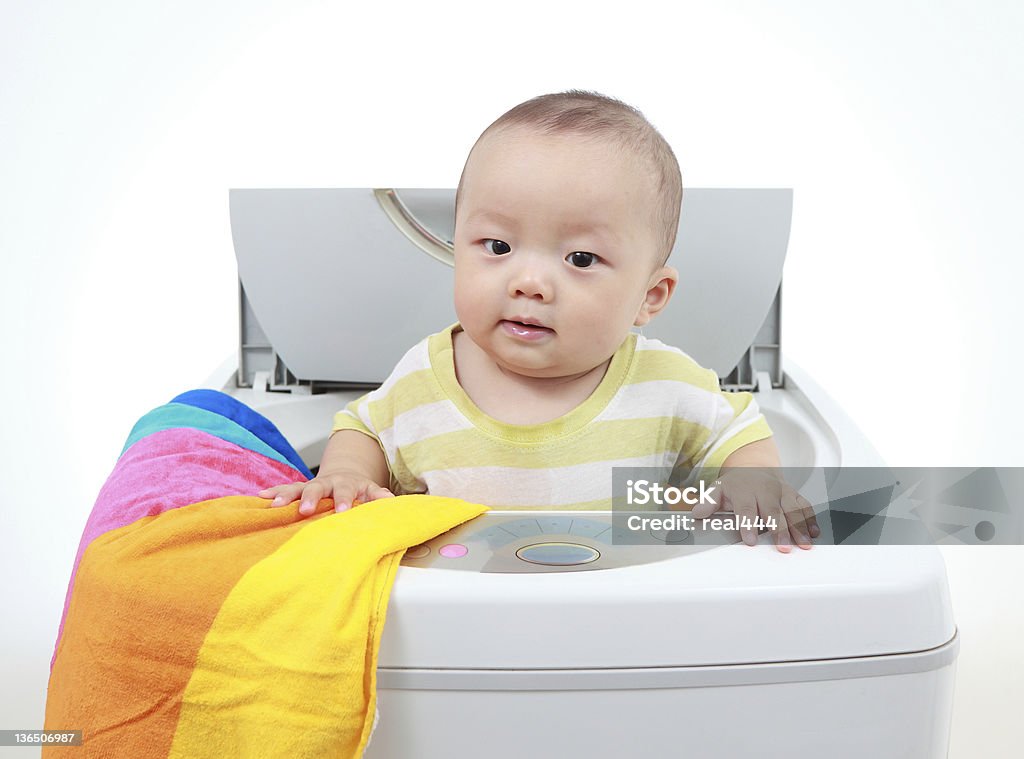 My baby and washing machine My son playing in the washing machine 6-11 Months Stock Photo