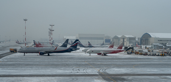 Moscow, Russia - January 12, 2022: Sheremetyevo International Airport. Passenger plane Boeing 777 of the Aeroflot. during a heavy snowfall. Terminal C in Sheremetyevo Airport outside