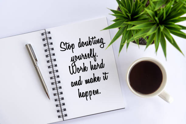 istock Stop doubting yourself. Work hard and make it happen. Positive text message on a notebook with morning coffee. 1365073542