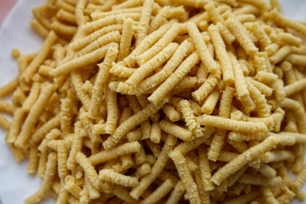 Raw homemade Passatelli. Traditional Italian pasta usually cooked in broth. Close up stock photo
