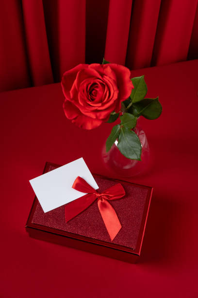 istock Valentine's Day blank message card with red rose and red gift box. Romantic love message. 1365081338