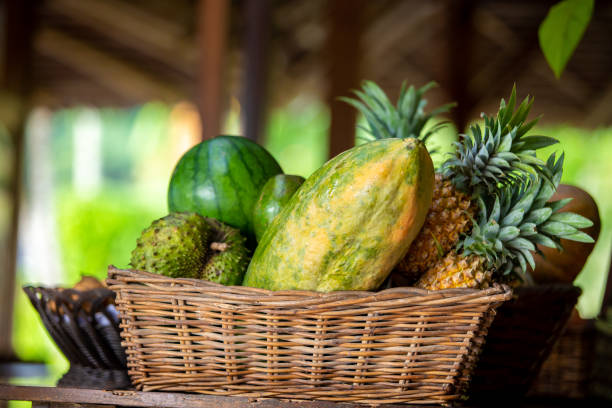 papaya, pineapple and other fruits on the basket papaya, pineapple and other fruits on the rattan basket annona muricata stock pictures, royalty-free photos & images
