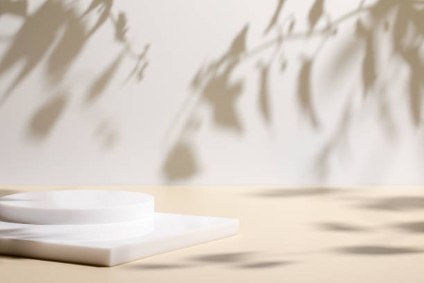 istock scene with white podium on beige background and shadows 1365084084