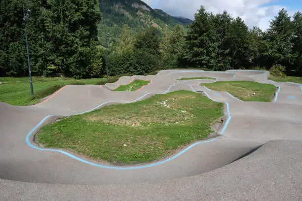 Photo of bicycle pumptrack circuit , outdoor race track surrounded by nature in Loudenvielle, France.