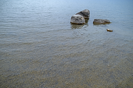 shallow lake shore, with large and small stones