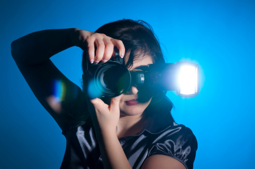 Attractive young photographer holding her camera