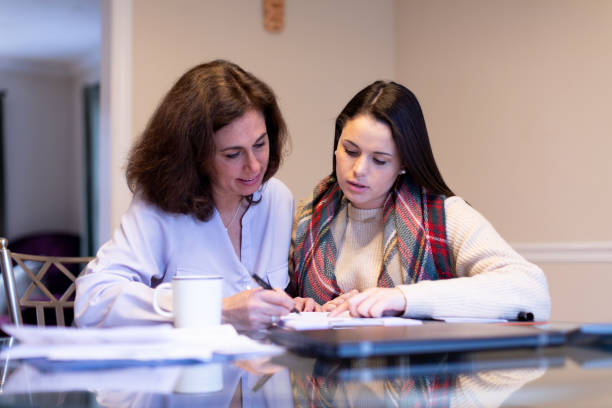 Mother advising daugther on university planning Mother advising on university selection to her daughter college student and parent stock pictures, royalty-free photos & images