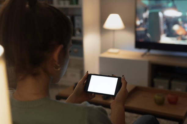 istock Teenager sitting on the couch and using her smartphone 1365087972