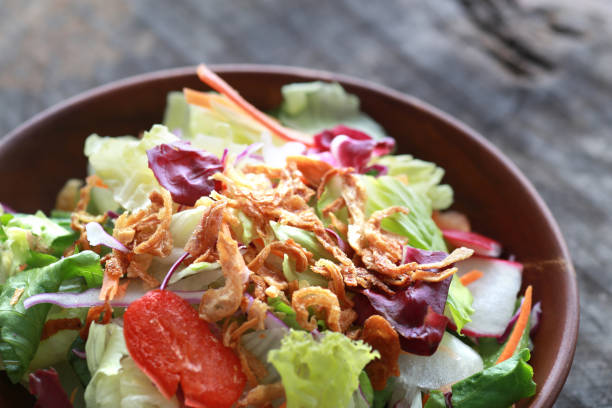 istock Fried onion topped with vegetable salad 1365088068
