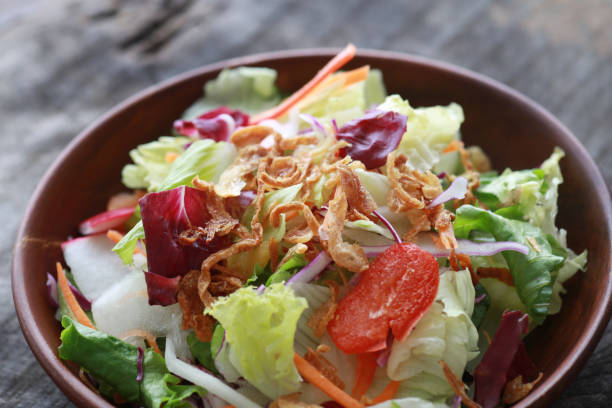 istock Fried onion topped with vegetable salad 1365088072