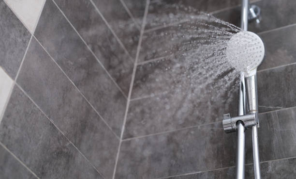 water is pouring from the shower head into the shower room - tap airplane imagens e fotografias de stock