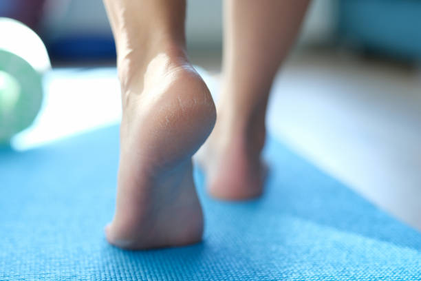 Barefoot dry feet make a step on a blue sports mat stock photo