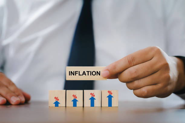 Businessman Hand holding a wooden block with the word inflation. and wood block with sign percent and arrow up symbol. financial growth, interest rate increase, inflation concept stock photo