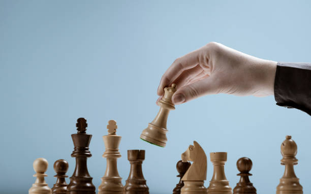 istock Player moving a piece on the chessboard 1365090720