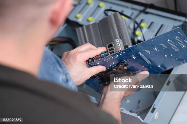 The Repairman Took Out The Motherboard From The Computer Stock Photo - Download Image Now