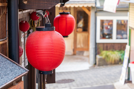 Japanese red lanterns hanging from the eaves of the shop