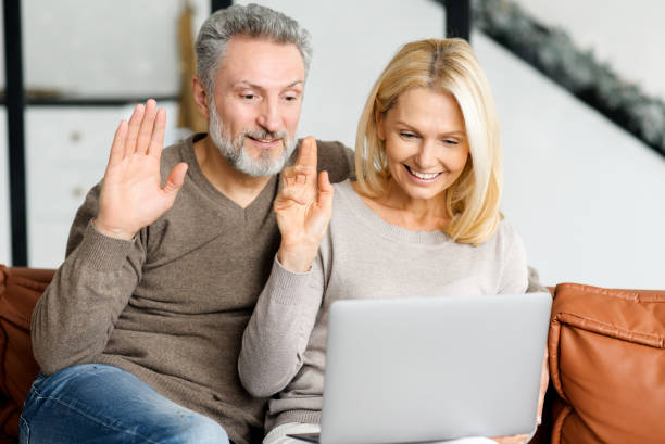 istock Mature spouses using laptop computer for online communication, video connection 1365094386