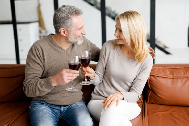 istock Harmonious mature married couple with wine having romantic date 1365094625