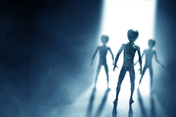 Silhouettes of aliens creature on dark background