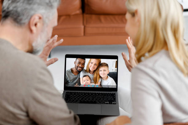 istock Middle-aged couple using laptop for video connection with grown daughter 1365096916