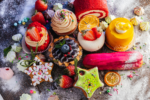 Variety of delicious confectionery products. A mix of chocolate mousse, eclair cakes, Cupcakes and Shu cakes for a candy bar, or a pastry shop showcase presentation.