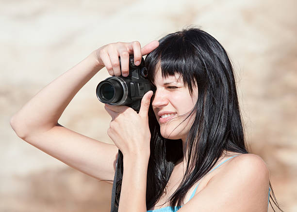 istock Young woman with digital camera 136509798