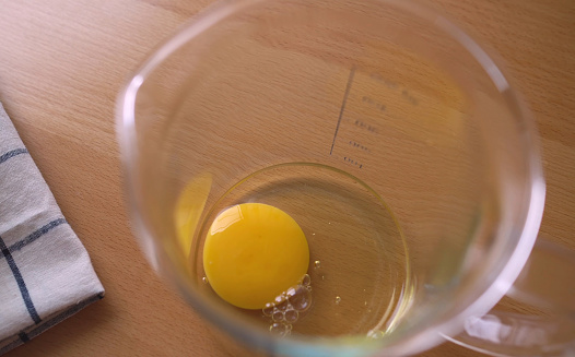 raw fresh egg yolk. egg yolks in a blender. Top view of raw egg in blender