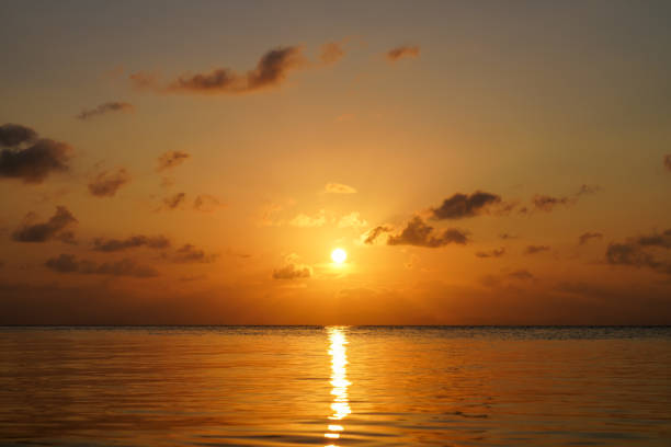 Seascape, sunset sky at the lake with small clouds on sky.