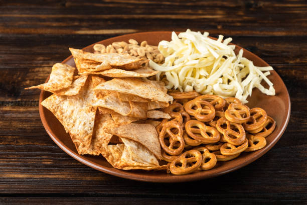 istock Pretzels and chips with cheese as an appetizer for beer 1365103491