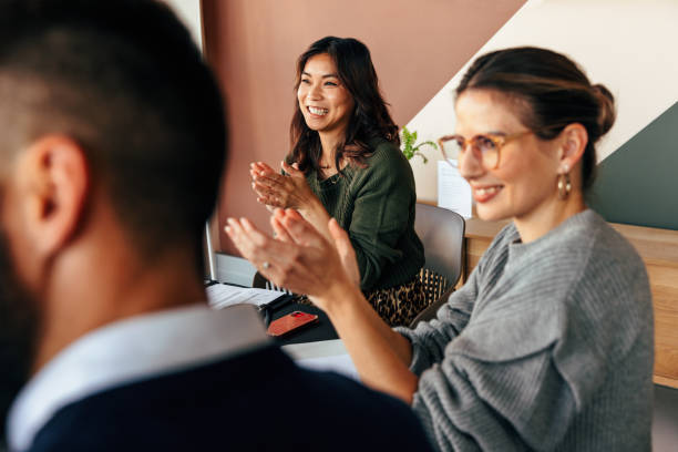 istock Cheerful businesspeople applauding during a meeting 1365105773