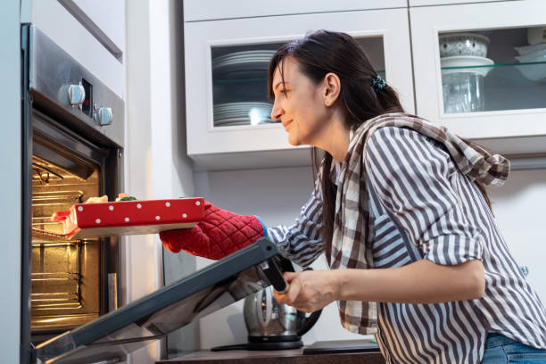 istock Young woman preparing food 1365106887