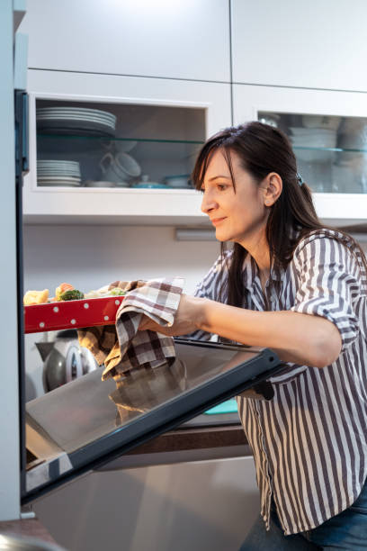istock Young woman preparing food 1365106968