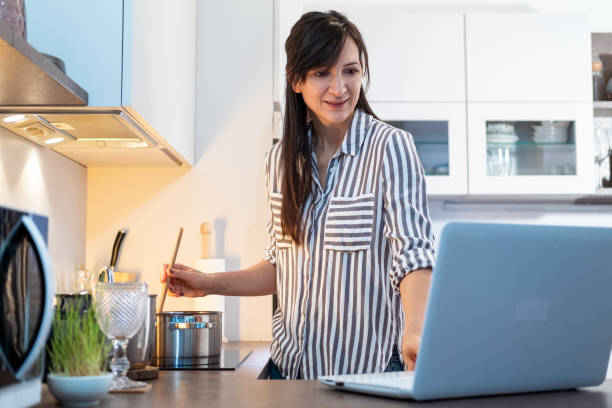 istock Young woman preparing food 1365107057