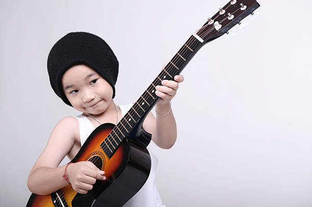 istock Young business kid with guitar 136510937