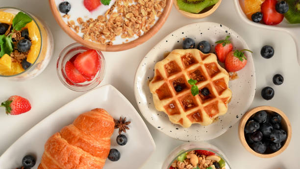 istock A healthy breakfast set with yogurt bowl, croissant, waffle on white table. 1365109543