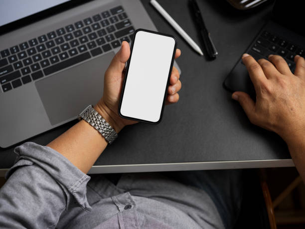 istock A businessman using his smartphone at his office desk. 1365109944