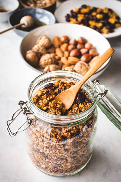 granola Homemade granola in a glass jar granola photos stock pictures, royalty-free photos & images
