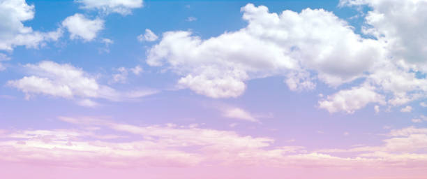 istock Romantic flirty fluffy soft clouds and pink blue sky background 1365111351