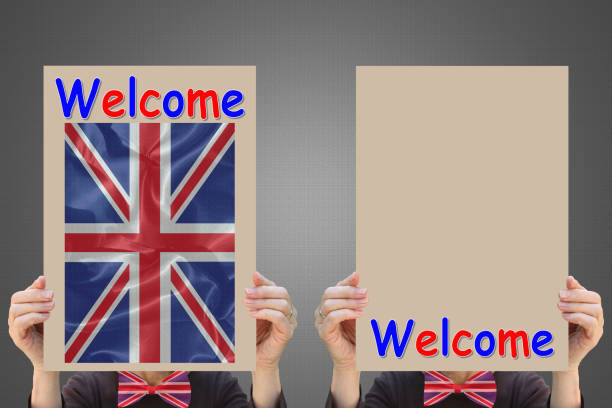 istock Hostesses holding welcome signs and UK flag 1365111506