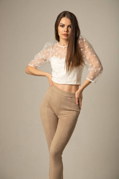 istock Beautiful woman with a model appearance on a light background 1365111686